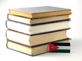 Jordanian flag with pile of books on white background