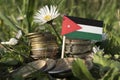 Jordanian flag with stack of money coins with grass