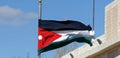 Jordanian flag waving in the wind in front of the tourist centre and visitor centre near the crusader castle in Karak, Jordan