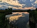 Josh`s Pond in Broomfield Colorado at Sunset reflecting off water, Rocky Mountains in the background Royalty Free Stock Photo