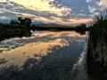 Josh`s Pond in Broomfield Colorado at Sunset reflecting off water, Rocky Mountains in the background Royalty Free Stock Photo