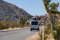 Joshua Tree National Park CA - A Mercedes Sprinter Van drives through on a sunny day