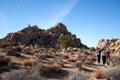 JOSHUA TREE NATIONAL PARK, CALIFORNIA, USA Ã¢â¬â DECEMBER 22, 2020: People with masks walking the trail in HIdden Valley of Joshua Royalty Free Stock Photo