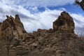 Joshua Tree National Park large rock formation with clouds and dark blue sky