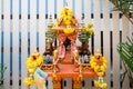 Joss house in thailand with flowers in vases and some wreathes