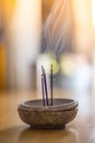 Smoking and smelling joss sticks at home, feng shui; Copy space