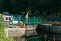 People preparing river locks on the river Oust near Josselin for houseboats to pass through