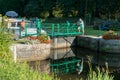 People preparing river locks on the river Oust near Josselin for houseboats to pass through