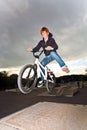 Joung red haired boy is jumping with his BMX Bike Royalty Free Stock Photo