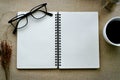 Journal book and eyeglasses with coffee in white cup Royalty Free Stock Photo