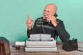 Journal or newspaper editor of the past. Work desk, typewriter and phone Royalty Free Stock Photo