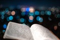 A journal notecopy placed outdoors at an evening against defocused lights of the city. writing blogging student concept. selective