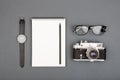 Journalist or blogger table - spiral blank notebook, pencil, camera and glasses on gray background, top view Royalty Free Stock Photo