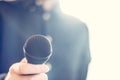 Journalist is holding a microphone in the foreground, blurry background