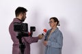 A journalist is interviewing a woman with a microphone and camera Royalty Free Stock Photo