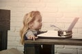 Journalist kid sitting at table and typing typewriter with paper Royalty Free Stock Photo