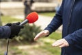 Journalist making media or vox populi interview with unrecognizable man on the street in the winter