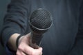 Journalist making speech with microphone and hand gesturing concept for interview. Royalty Free Stock Photo