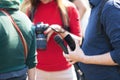 Reporter at media event holding microphone, blurred female photographer in the background