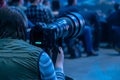 Journalist photographer with a telephoto lens at work