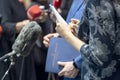 Journalist taking notes at media event, news or press conference. Journalism concept.