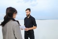 journalist woman and race driver shake hands after interview