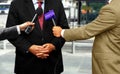 Journalists with microphones interviewing corporate spokesperson