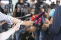 Reporters at press conference holding microphone and smartphone making media interview with unrecognizable politician or business Royalty Free Stock Photo