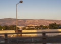 Journey along the E75 in Central Greece within the city of Athens with a view from afar to the Acropolis at sunset Royalty Free Stock Photo