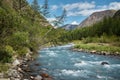 Journey through Altai Mountains, amazing nature of mountain peaks, rivers and streams flow down from slope of mountains. Altai