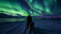 Journey Beneath the Aurora: Solo Traveler and Sled Dogs in the Arctic Royalty Free Stock Photo