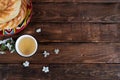 journey cake bread on adras plate and teabowl with white cherry flowers on wooden background