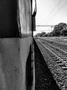 And the journey starts from here view of train and tracks in black and white filter with some sunshine in the color . Royalty Free Stock Photo