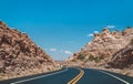 Stone desert in the USA. A picturesque road in the lifeless red rocks of Arizona Royalty Free Stock Photo