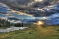 Journey through the wild nature of the Altai. Sunset in the valley of the mountain river Bashkaus.