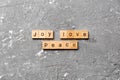 Joy love peace word written on wood block. joy love peace text on cement table for your desing, concept Royalty Free Stock Photo