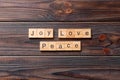 Joy love peace word written on wood block. joy love peace text on cement table for your desing, concept Royalty Free Stock Photo