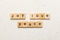 joy love peace word written on wood block. joy love peace text on cement table for your desing, concept Royalty Free Stock Photo