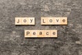 joy love peace word written on wood block. joy love peace text on cement table for your desing, concept Royalty Free Stock Photo