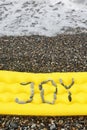 Joy message from pebbles on a air-bed.