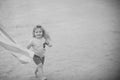 Joy of resting the child at sea. Kid small boy with smiling happy face running along beach Royalty Free Stock Photo