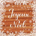 Joyeux Noel calligraphy hand lettering on wood background with snowflakes. Merry Christmas typography poster in French. Easy to Royalty Free Stock Photo