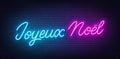 Joyeux Noel neon lettering on brick wall background. Merry Christmas greetings in French. Royalty Free Stock Photo