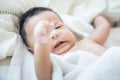 Joyful adorable infant baby boy lying on white blanket Royalty Free Stock Photo