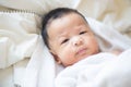 Joyful adorable infant baby boy lying on white blanket Royalty Free Stock Photo