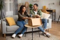 Joyful African American Couple Unpacking Cardboard Box Receiving Parcel Indoor Royalty Free Stock Photo