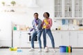 Joyful african american family having fun while cleaning kitchen together Royalty Free Stock Photo