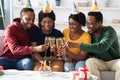 Joyful african american men and women celebrating birthday at home Royalty Free Stock Photo