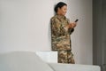 Joyful african american military woman is standing in living room Royalty Free Stock Photo