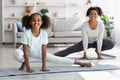 Joyful african american mother and daughter stretching at home Royalty Free Stock Photo